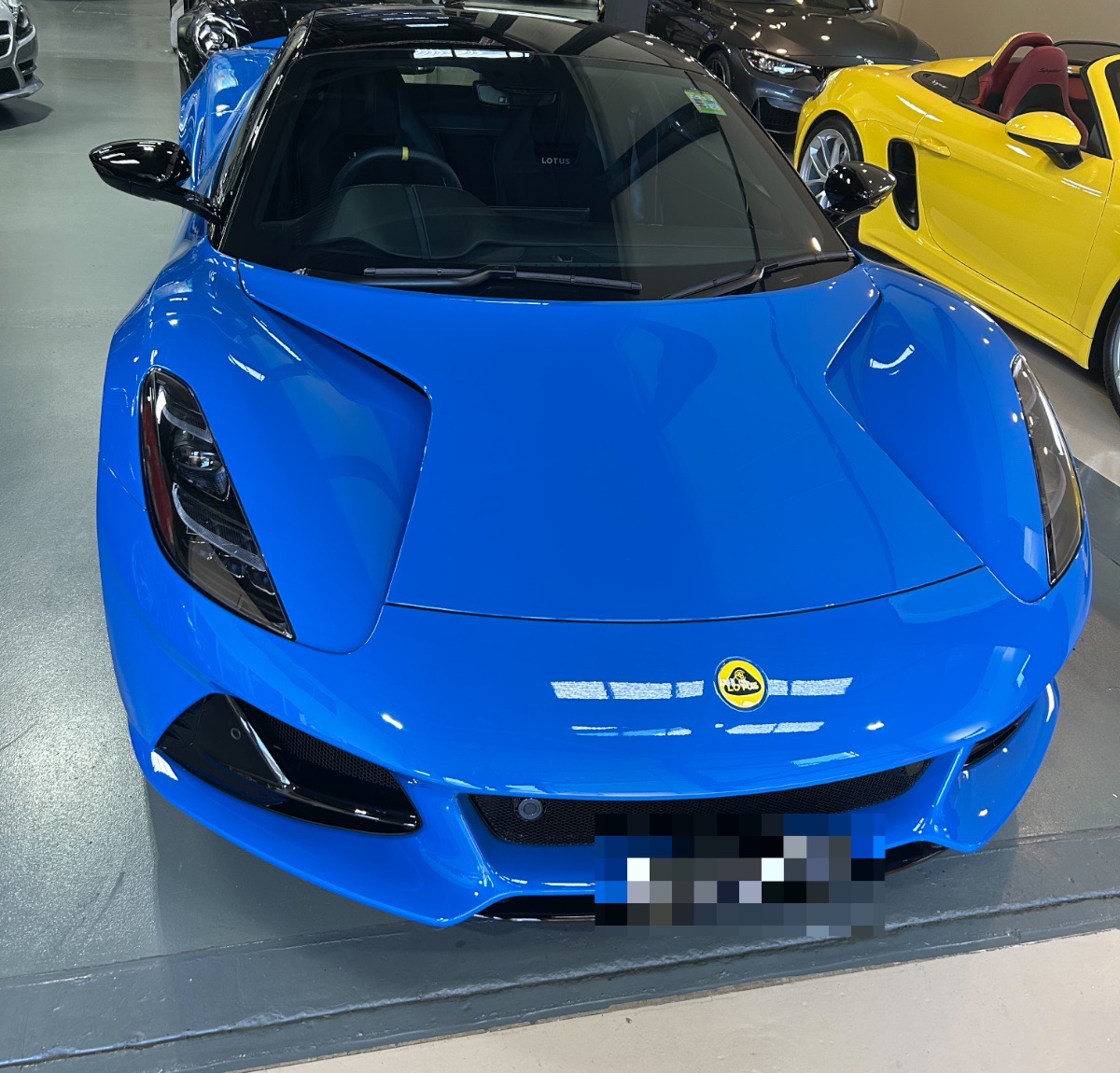 A Lotus Emira in racing blue, photographed by us at a Sydney exotics den. Photography: Queen of Cars.